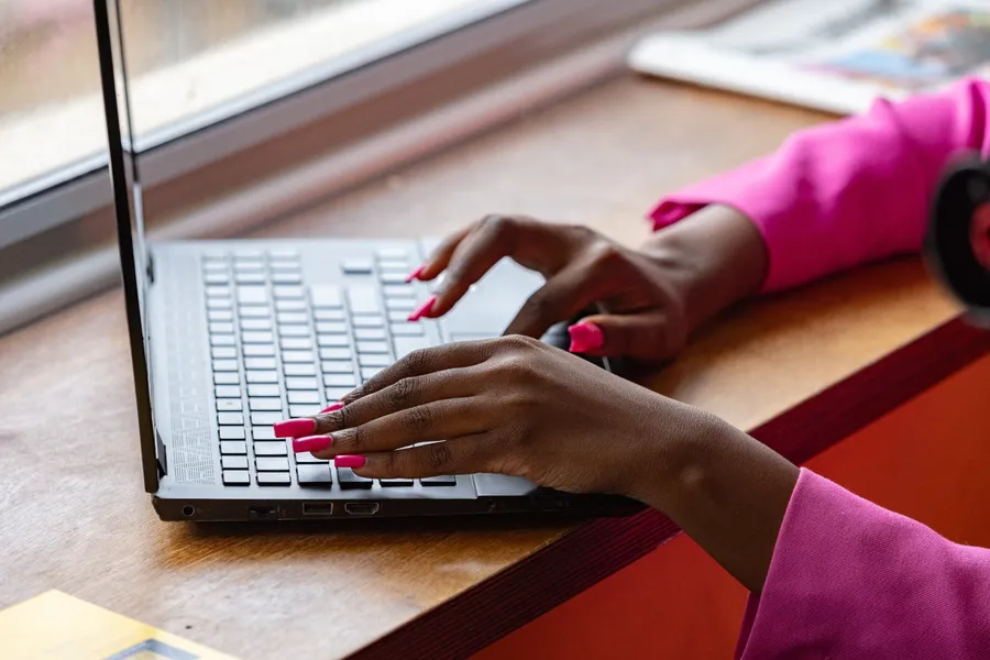Vanessa Challess, founder of Electra HR, typing at her desk